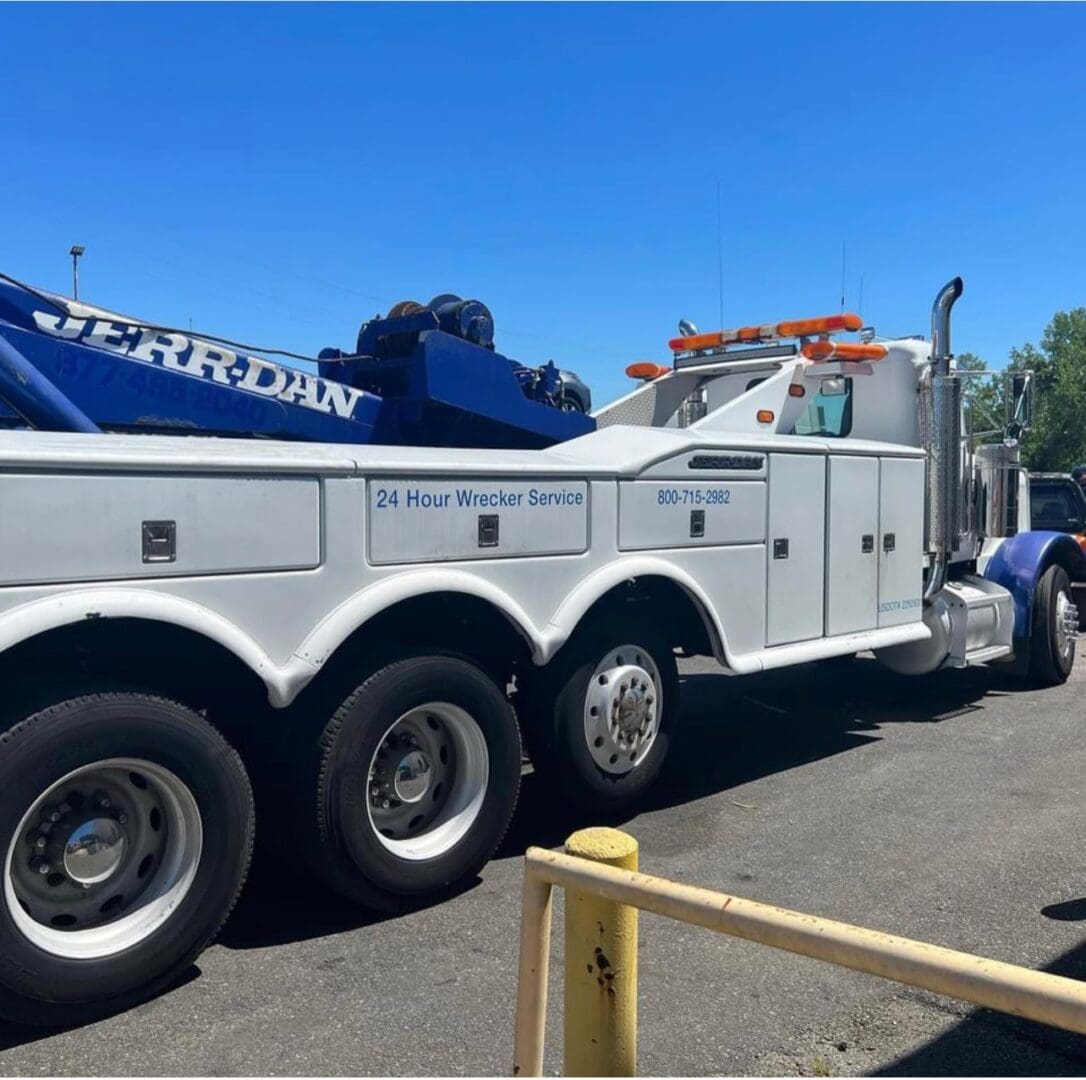 A large tow truck parked in the parking lot.